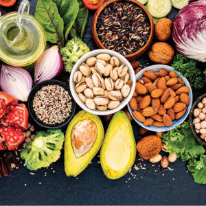 large display of fruits, vegetables, nuts, eggs, leafy greens on table